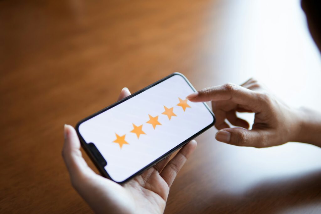 Customer review good rating concept hand pressing five star on website and positive customer.
