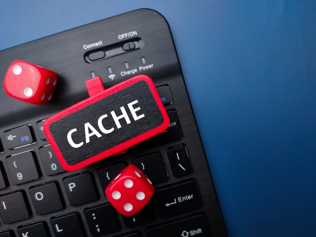 Keyboard and red dice with the word CACHE. Business concept